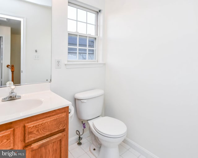 bathroom featuring tile patterned floors, vanity, and toilet