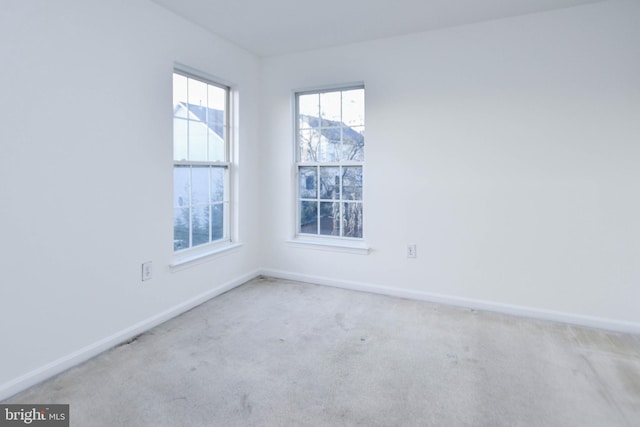 unfurnished room with light carpet