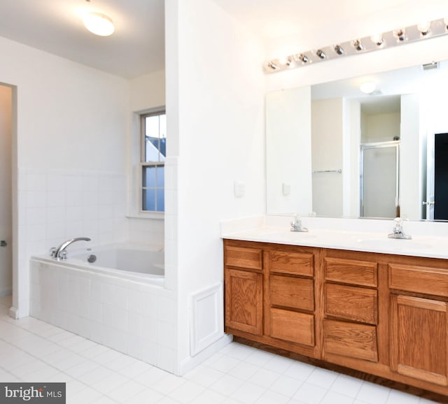 bathroom featuring tile patterned floors, vanity, and independent shower and bath