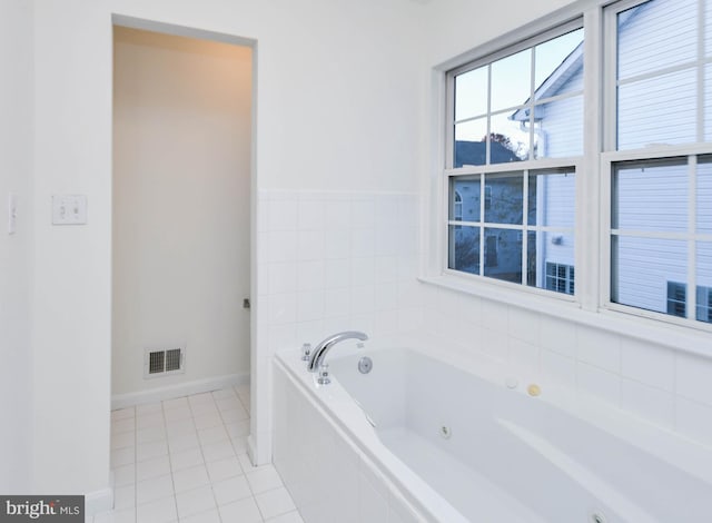 bathroom featuring tile patterned floors and tiled tub