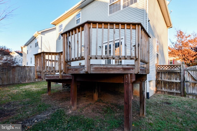 back of house with a yard and a wooden deck