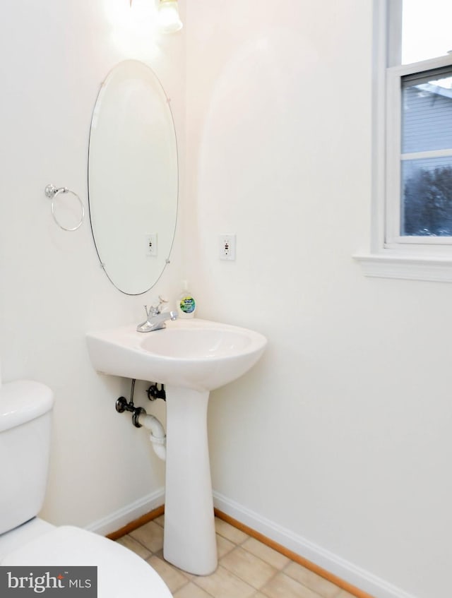 bathroom featuring tile patterned flooring and toilet