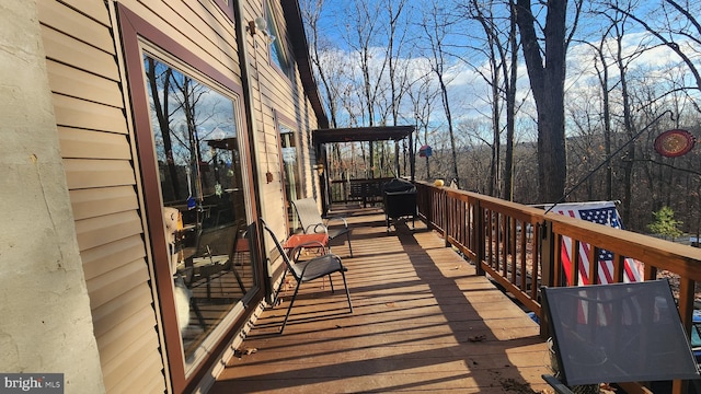 wooden terrace with area for grilling