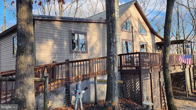 rear view of property with a wooden deck