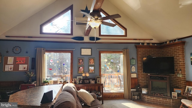 carpeted living room featuring ceiling fan, a fireplace, and high vaulted ceiling