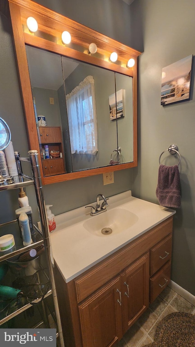 bathroom featuring tile patterned flooring and vanity