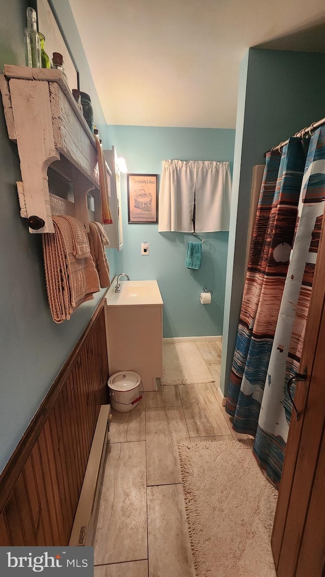 bathroom featuring sink and baseboard heating