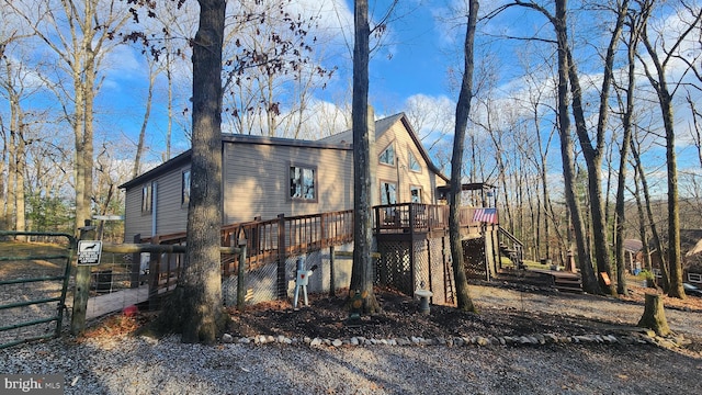 view of side of property featuring a wooden deck