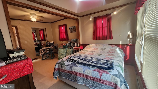 bedroom featuring carpet, ceiling fan, and crown molding