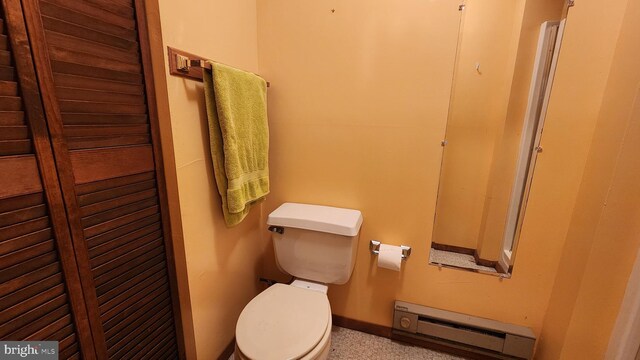 bathroom featuring toilet and a baseboard heating unit