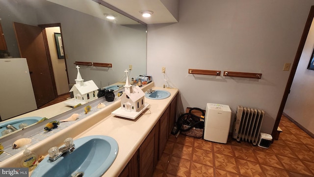 bathroom featuring vanity, radiator heating unit, and parquet floors