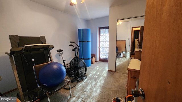 exercise area with carpet flooring and ceiling fan