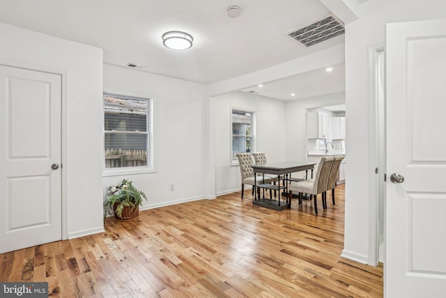 dining space featuring a wealth of natural light and light wood-type flooring