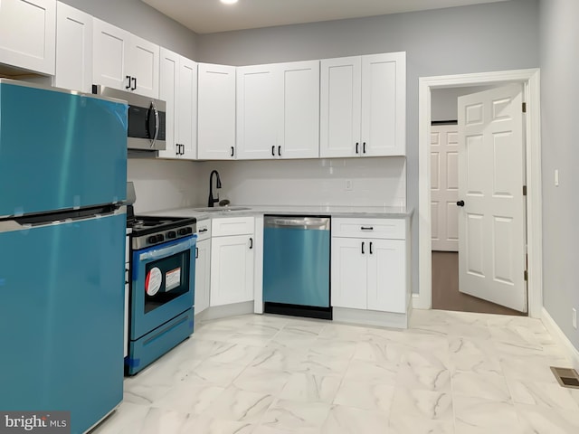 kitchen with white cabinetry, sink, and appliances with stainless steel finishes