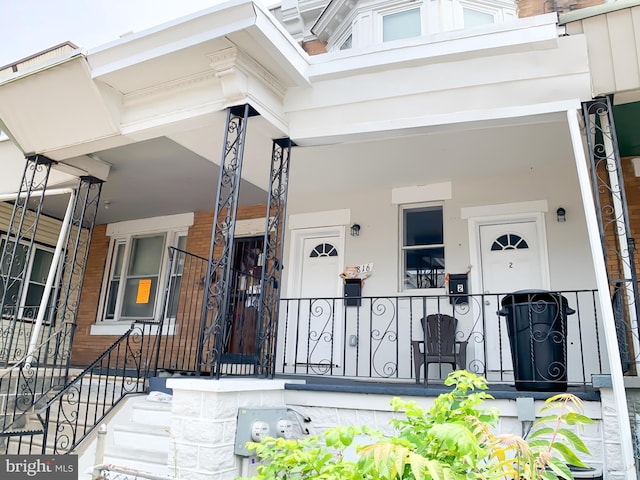 view of exterior entry featuring a porch