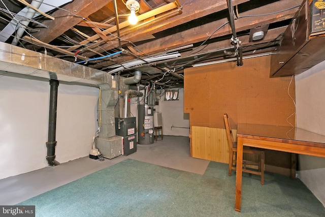 basement featuring heating unit and water heater