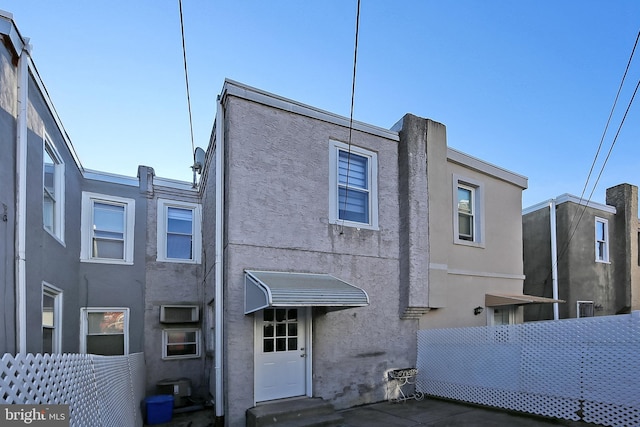 back of house with central air condition unit