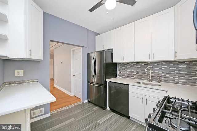 kitchen with dark hardwood / wood-style flooring, white cabinetry, sink, and appliances with stainless steel finishes