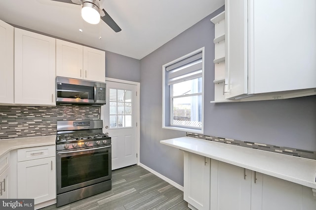 kitchen with ceiling fan, decorative backsplash, white cabinets, and appliances with stainless steel finishes