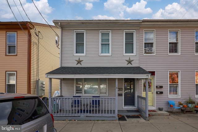 townhome / multi-family property featuring covered porch