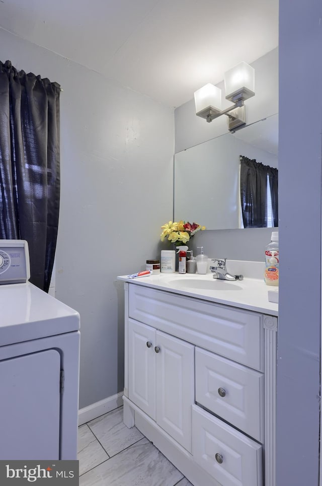 bathroom featuring vanity and washer / clothes dryer