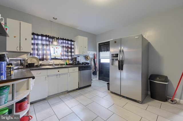 kitchen with plenty of natural light, white cabinetry, and appliances with stainless steel finishes