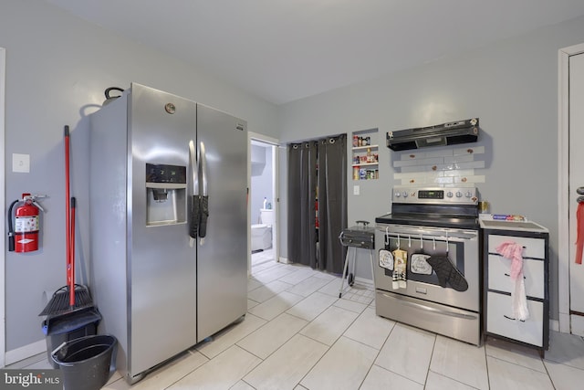 kitchen featuring ventilation hood, backsplash, stainless steel appliances, and light tile patterned floors