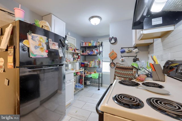 kitchen featuring white cabinets, black fridge, white electric stove, decorative backsplash, and extractor fan