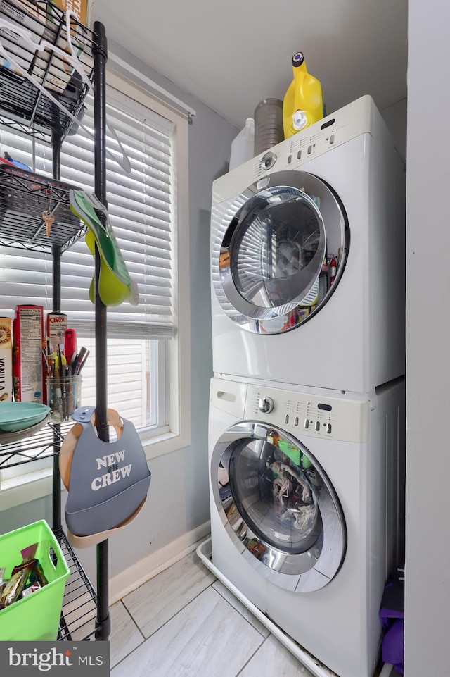 laundry area featuring stacked washer / dryer