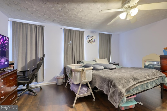 bedroom featuring a textured ceiling, dark hardwood / wood-style floors, and ceiling fan