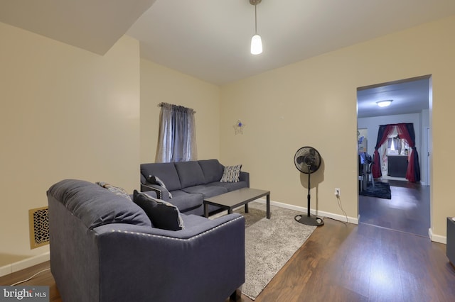 living room with dark hardwood / wood-style flooring