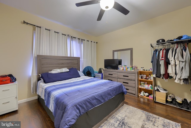 bedroom with ceiling fan and dark hardwood / wood-style flooring