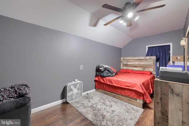 bedroom featuring ceiling fan, dark hardwood / wood-style flooring, and vaulted ceiling