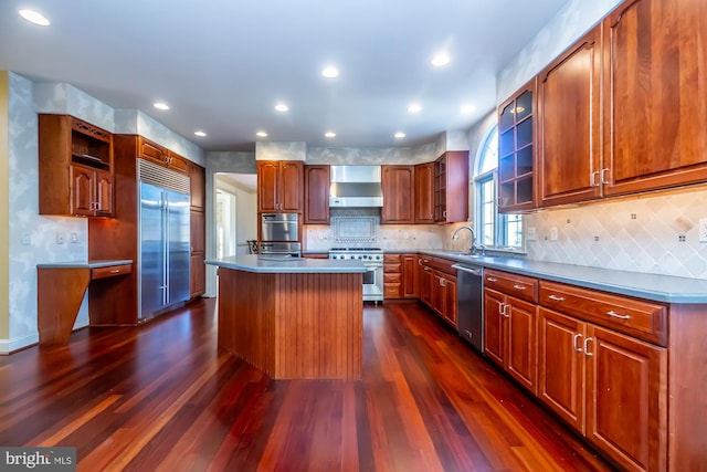 kitchen with a center island, dark hardwood / wood-style floors, extractor fan, and high quality appliances