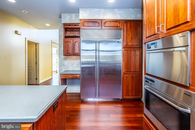 kitchen with dark hardwood / wood-style flooring and stainless steel appliances