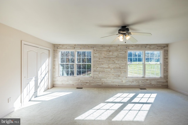 spare room featuring light carpet and ceiling fan