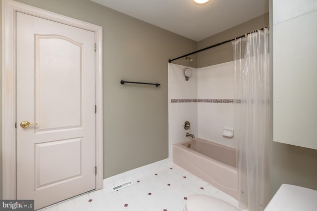 bathroom with toilet and shower / tub combo with curtain