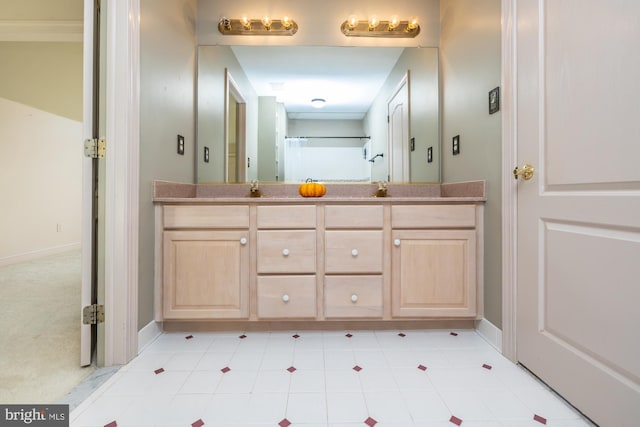 bathroom featuring vanity and ornamental molding