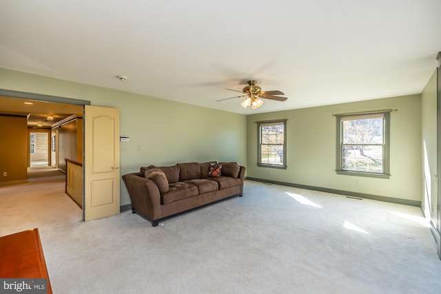 carpeted living room featuring ceiling fan