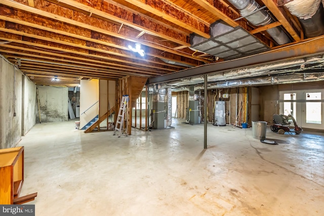 basement featuring heating unit and water heater