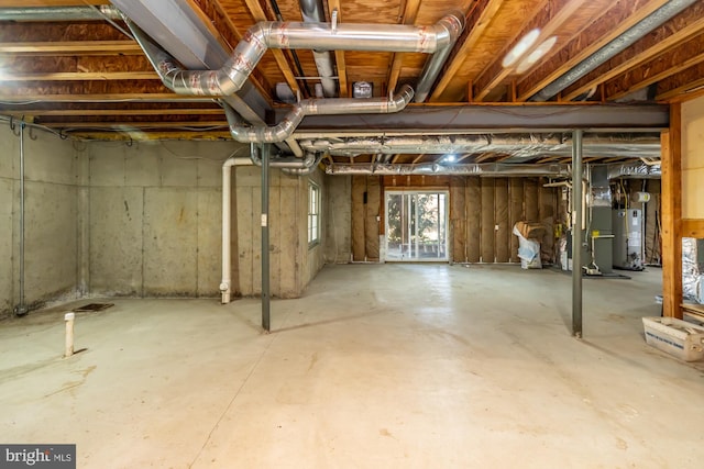 basement featuring gas water heater and heating unit