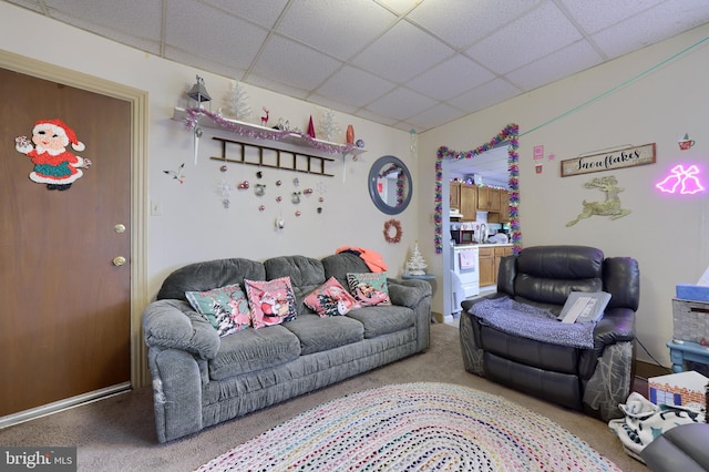 living room with carpet and a paneled ceiling