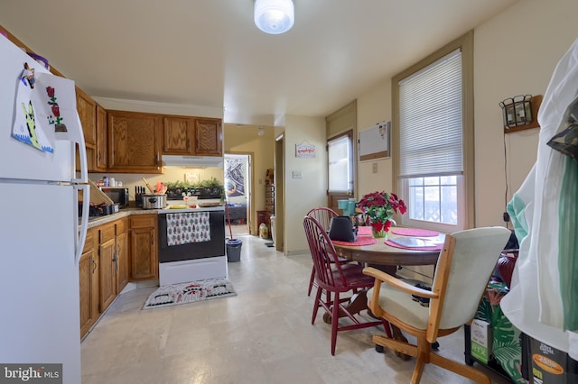 kitchen with range and white fridge