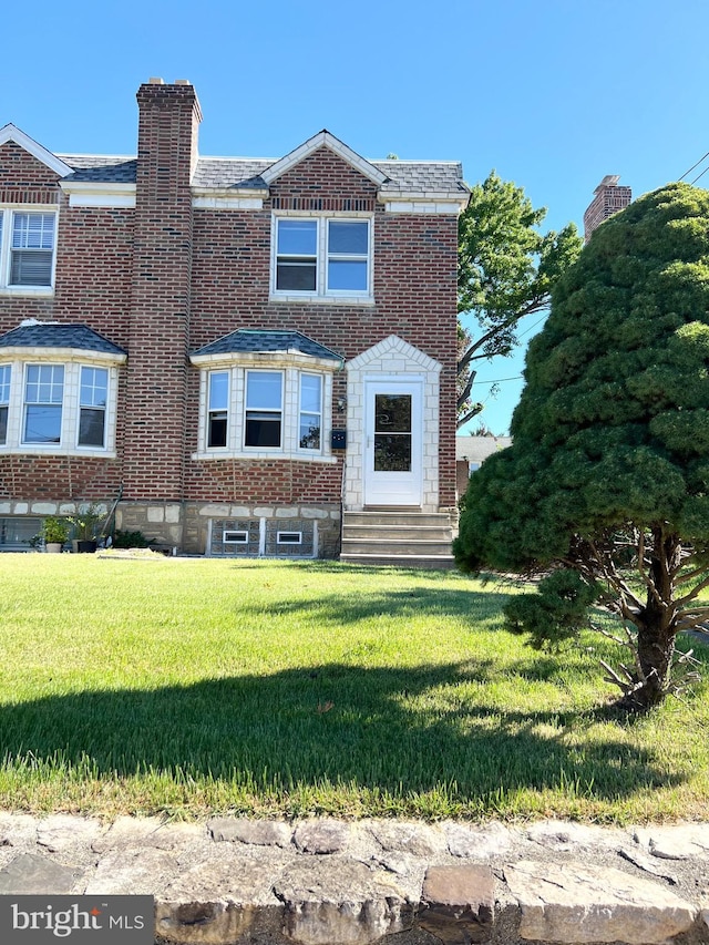 1807 Chandler St, Philadelphia, PA 19111 - view of front facade with entry steps, a front yard, brick siding, and a chimney