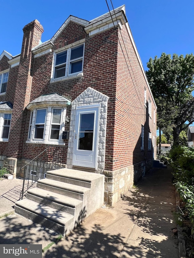 1807 Chandler St, Philadelphia, PA 19111 - view of property featuring brick siding and a chimney