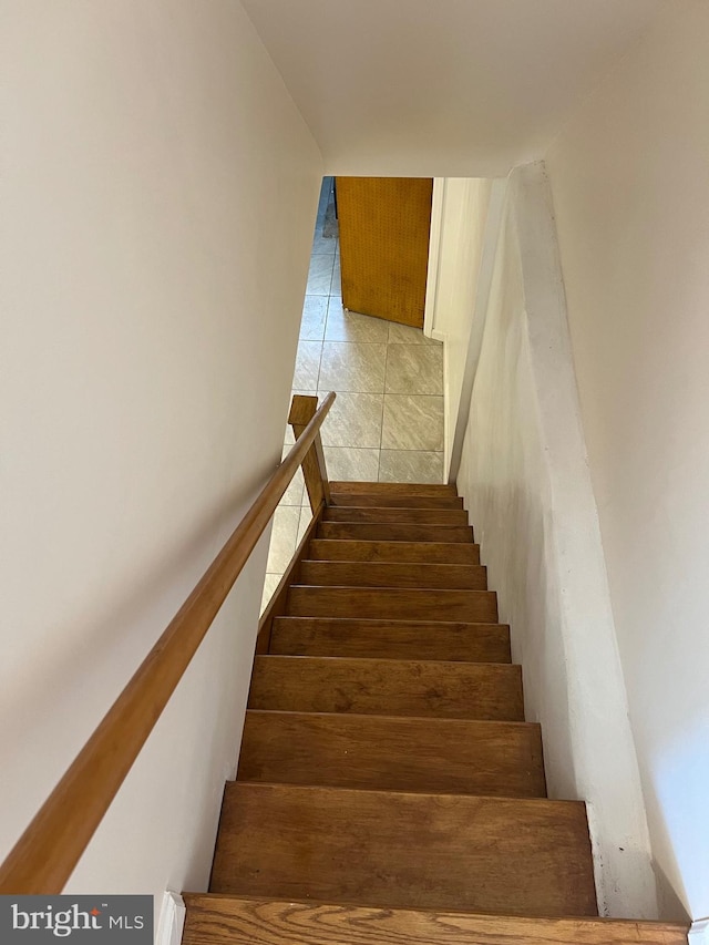 stairway with tile patterned floors