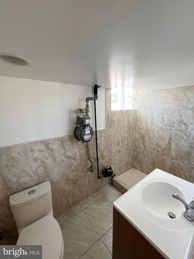 bathroom featuring tile patterned floors, vanity, and toilet