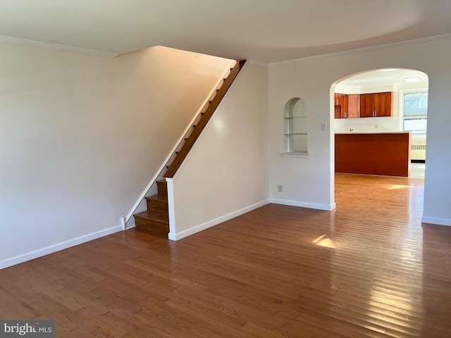 1807 Chandler St, Philadelphia, PA 19111 - unfurnished living room with ornamental molding, arched walkways, wood finished floors, baseboards, and stairway