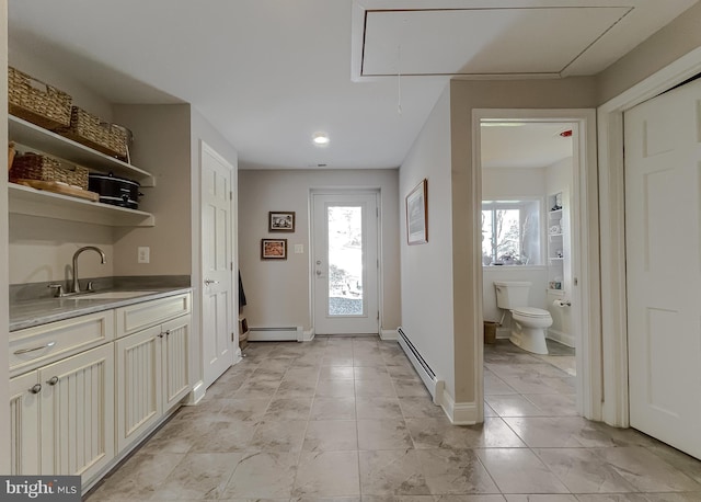 entryway with sink and a baseboard heating unit