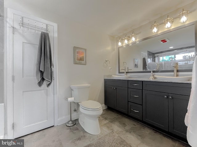 bathroom featuring vanity and toilet